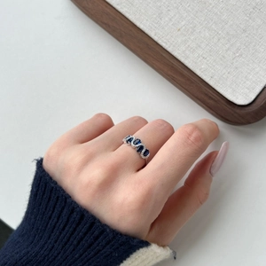 Close-up of S925 sterling silver ring featuring a large blue oval gemstone and diamonds