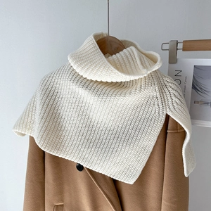 Detailed view of the thick knit texture and high neck design of this beige scarf