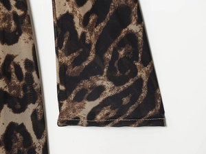 Close-up of leopard print mini dress featuring fine overlock stitching on mesh fabric