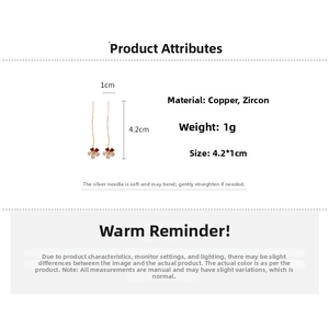Detailed view of gold clover tassel earrings with dimensions 4.2cm by 1cm and zircon inlay