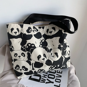 Detailed view of panda pattern on canvas tote bag with black strap and zipper closure