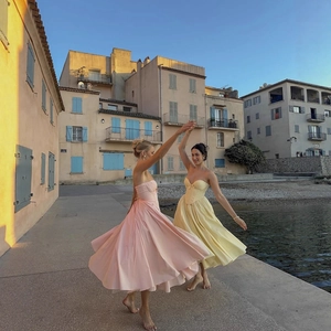 Elegant strapless corset maxi dress with bow detail in pink and yellow floral style