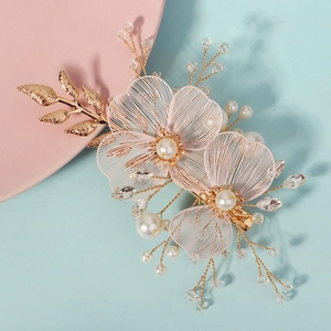 Handmade bridal hair clip with pink mesh flowers, pearls and golden leaves on pink tray