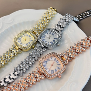 Detailed view of square quartz watches in gold, silver, and rose gold with crystals