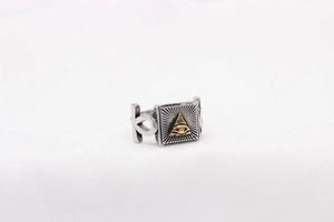 Macro detail of retro stainless steel ring with gold Masonic eye relief and antique finish