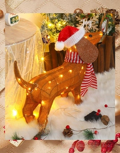 Detail of light up Christmas dachshund with warm LED lights and cozy festive accessories