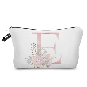 Close-up detail of white makeup bag featuring a pink letter E with elegant floral pattern