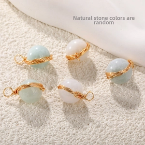 Detailed view of five wire-wrapped natural stone pendants in green and white tones
