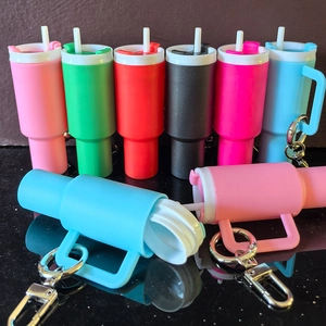Miniature tumbler cup keychains in various colors for backpack and lip balm storage
