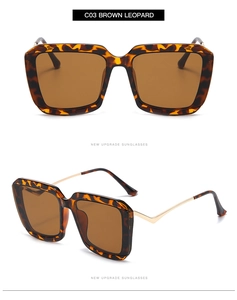 Macro detail of brown leopard square sunglasses with golden metal temples on white background