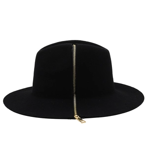 Macro detail of high-quality black wool fedora featuring a stylish gold zipper accessory