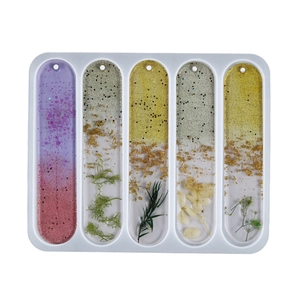 Detailed 5-hole silicone bookmark mold with gold foil and dried flowers resin samples