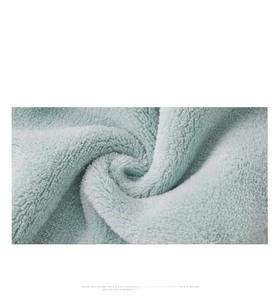 Macro shot of light green coral fleece fabric with soft texture and high absorption
