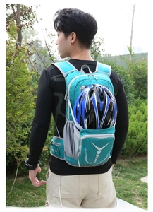 Outdoor cycling backpack in teal featuring helmet storage mesh and reflective safety details