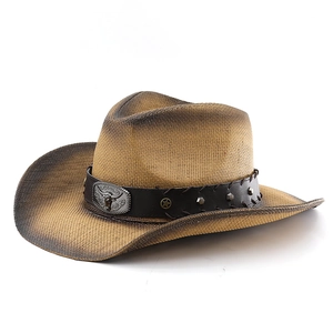 Detail of western straw cowboy hat with bull head emblem and vintage burnt edges