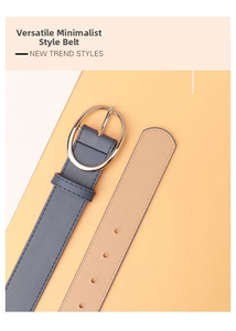 Close-up of stylish PU leather belt with silver oval buckle on a dual-tone background