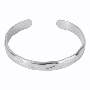 Detail shot of the irregular hammered texture on the silver stainless steel open bangle