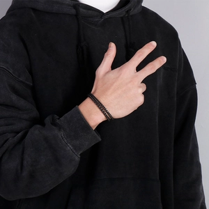 Close-up of a matte black double-layered braided chain bracelet for men in punk style