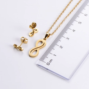Detailed size measurement of golden infinity pendant and earrings set against a clear ruler