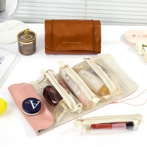 Detail of travel makeup bag with detachable mesh pouches and a roll-up leather case