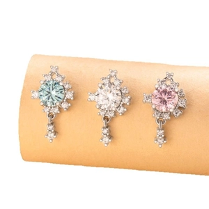 Three variants of silver titanium steel earrings with zircon pendants in blue, white, and pink