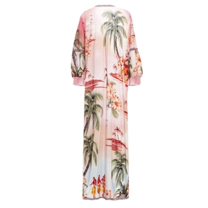 Detail of tropical palm tree and beach landscape print on a long sleeve pink maxi dress