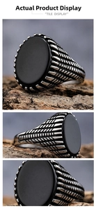 Detailed macro view of retro stainless steel ring with black oval gemstone and textured sides