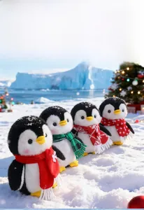 Group of four plush penguins with festive scarves in a snowy outdoor Christmas setting