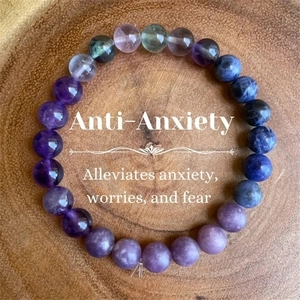 Top view of anti-anxiety natural stone beaded bracelet on a rustic wood tray