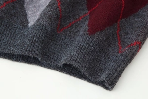 Close-up of argyle knit pattern and ribbed hem on a vintage casual sweater
