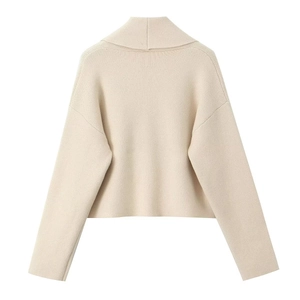 Back view of cream knit cardigan featuring a large turn-down collar and dropped shoulders