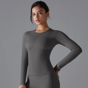 Detail of charcoal grey long sleeve yoga top with brushed texture and stretch fit