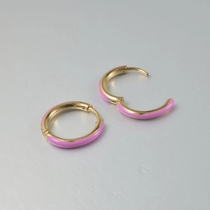 Detail of pink enamel coated gold earrings showing the secure hinge closure mechanism