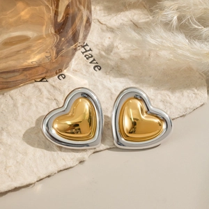 Detail of vintage heart stud earrings with two-tone gold and silver polished finish