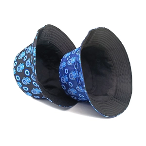 Detail view of cotton bucket hats with blue Hamsa Hand and Evil Eye patterns