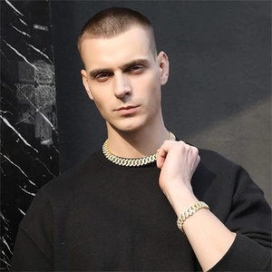 Men's bold hip hop gold Cuban link chain necklace and bracelet set on male model