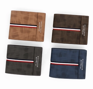 Macro detail of men's matte bifold wallets in four colors showing textured leather finish