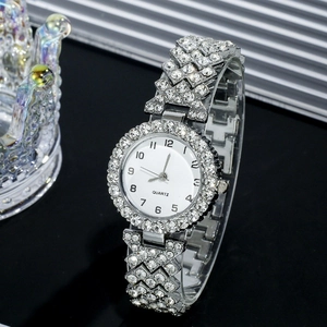 Detailed close-up of a silver rhinestone-studded quartz watch with a white numeric dial