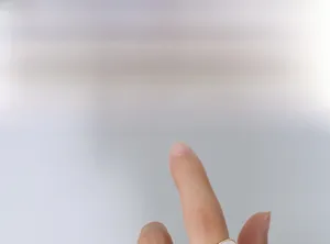 Detail shot of an 18k gold plated oval white shell ring worn on a finger