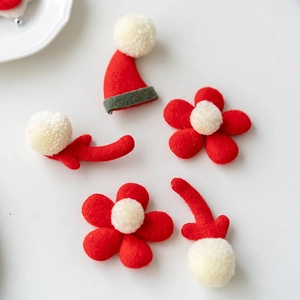 Handmade red felt Christmas DIY set with Santa hat, flowers, and reindeer antlers