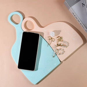 Minimalist resin coaster trays in mint green and peach pink with white stone textures