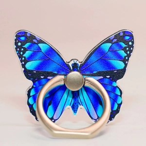 Macro detail of butterfly phone ring holder with blue wings and gold metal stand