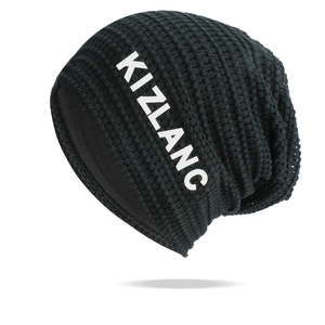 Detail of black waffle-knit beanie featuring white KIZLANC letter print on the side