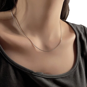 Minimalist silver stainless steel chain necklace on model for a modern aesthetic look
