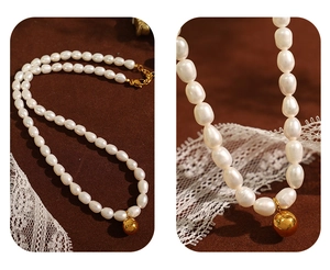 Detailed macro view of irregular freshwater pearls with a polished golden sphere pendant
