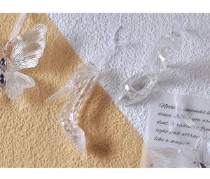 Detailed view of clear acrylic high heels and butterfly ornaments with multifaceted finish