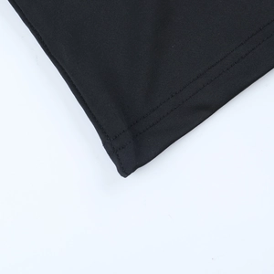 Close-up of high-quality double-needle stitching on the hem of a black lace V-neck top