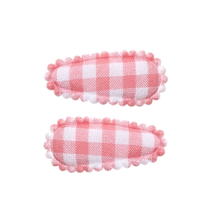 Close-up of pink and white checkered fabric BB hair clips with scalloped stitched edges