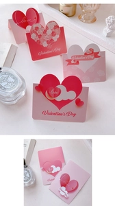 Detailed close-up of 3D pop-up Valentine's Day cards with heart and rose paper cutouts