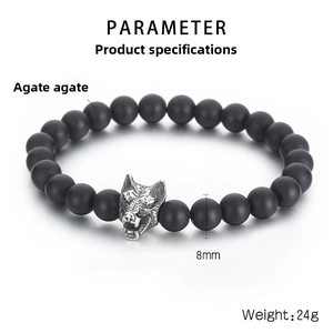 Detailed view of matte black onyx 8mm beads with a vintage silver wolf head charm